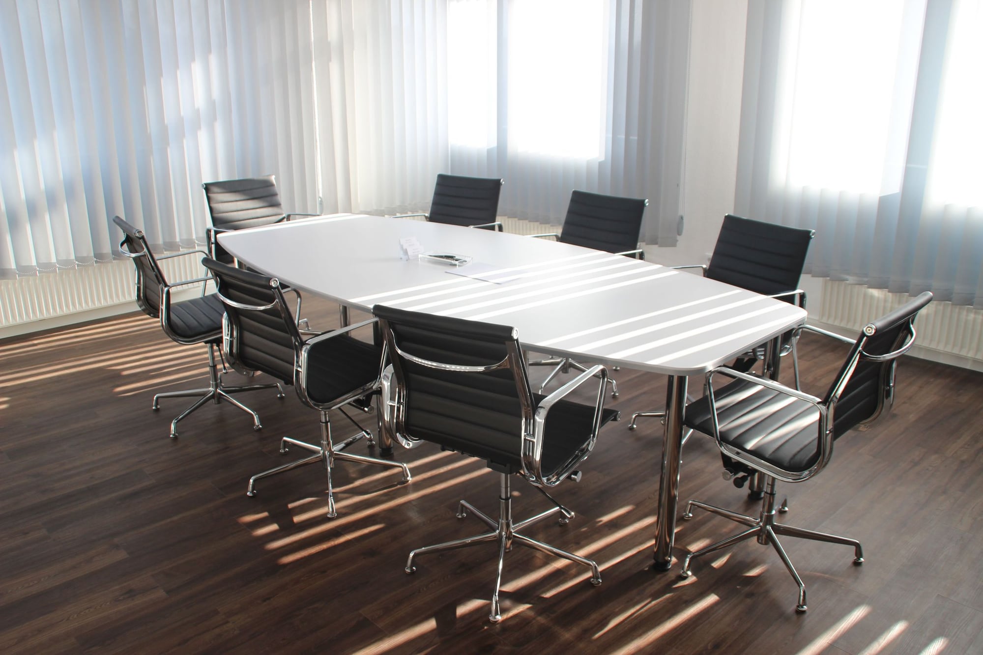 Partner briefing across the desk, documents in review